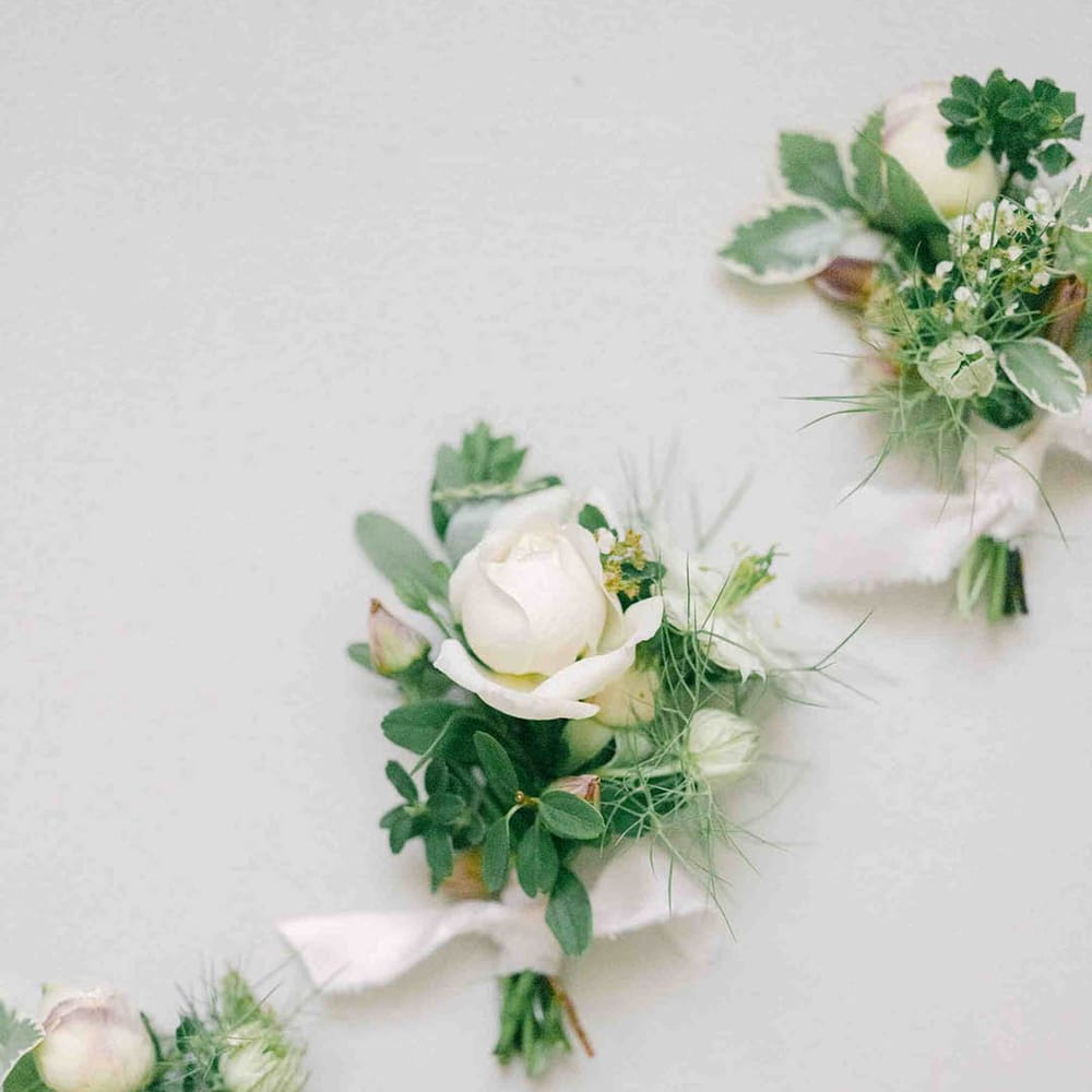 delicate white rose buttonhole flowers 