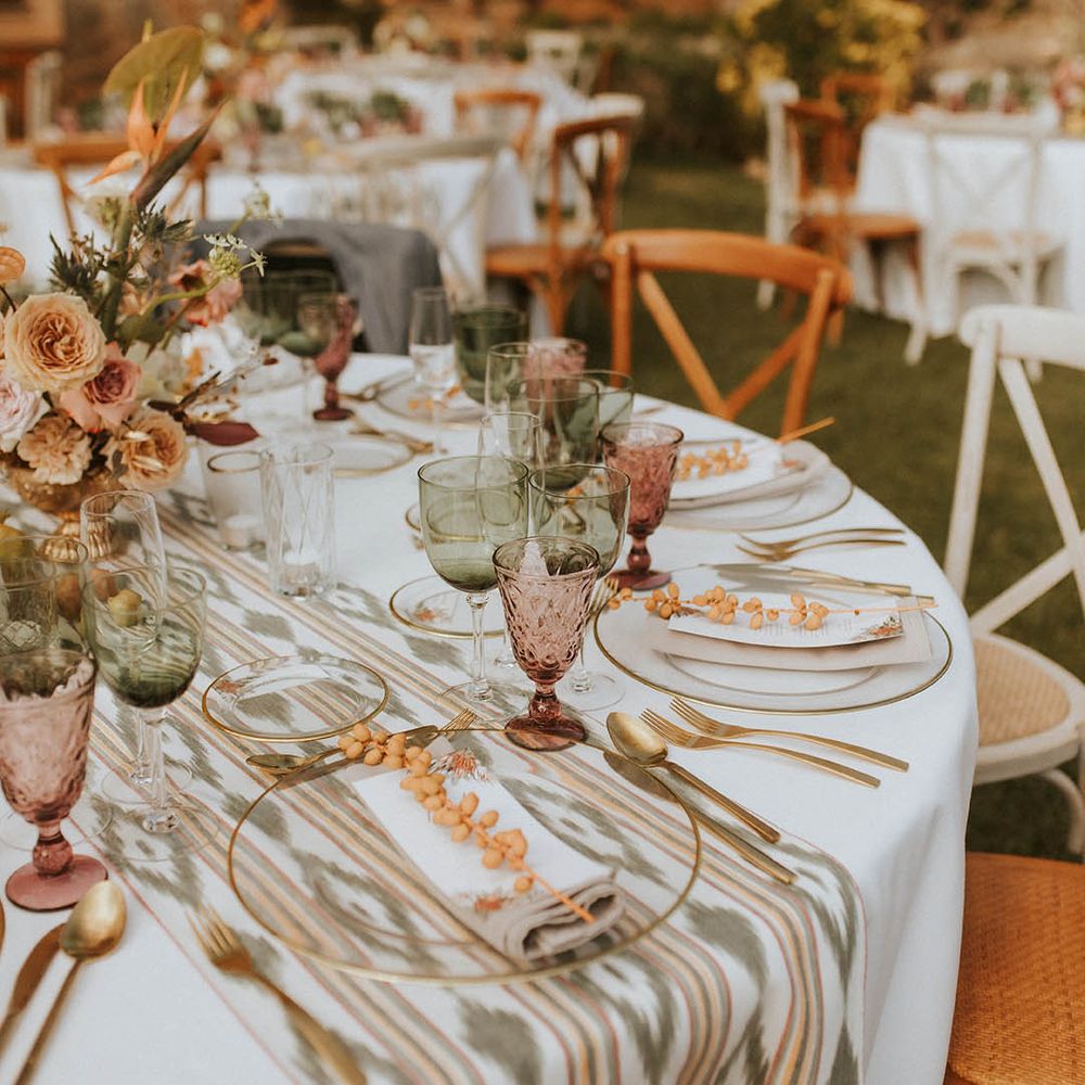 Outdoor reception complete with white table clothes and Moroccan inspired table runner 