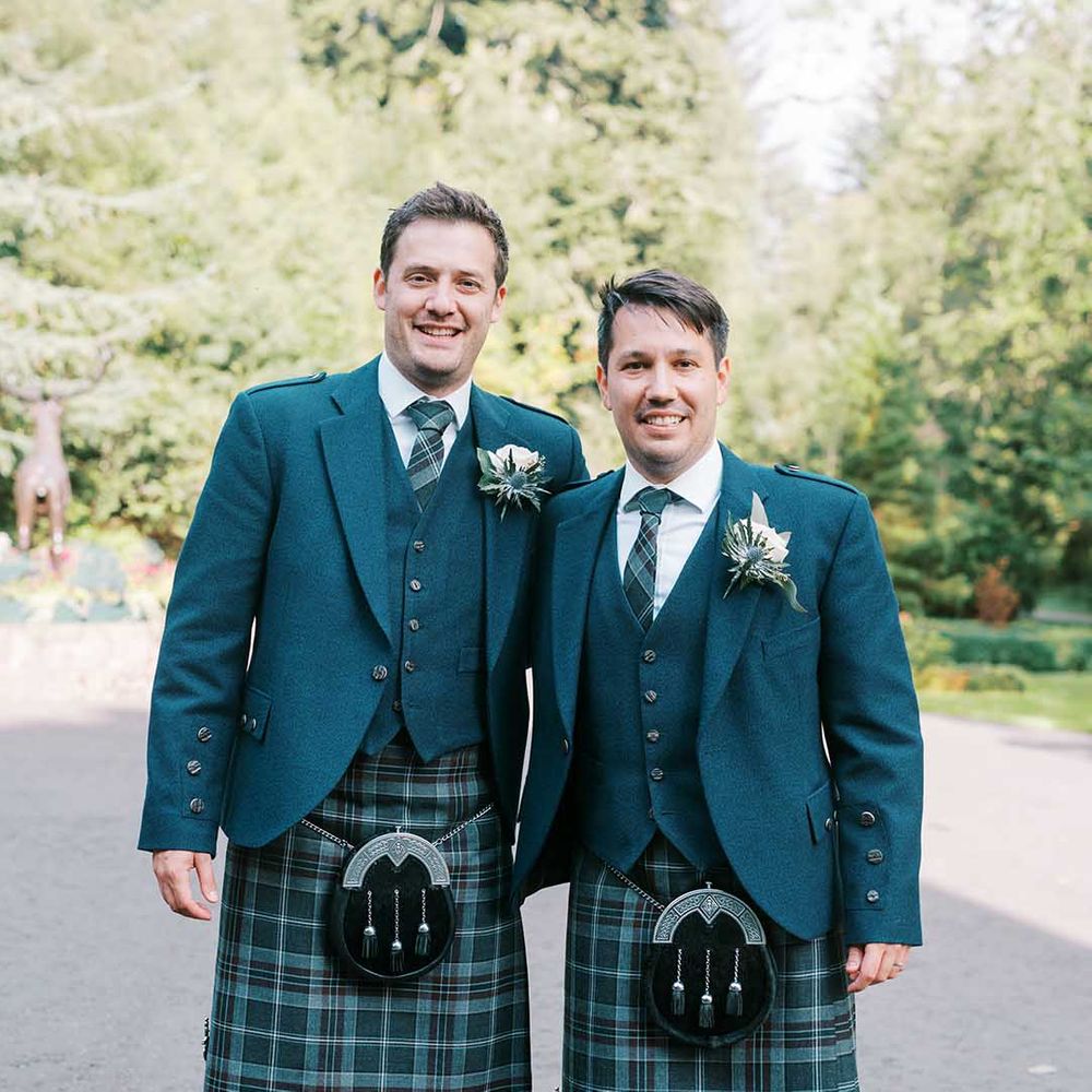 Groom and groomsman in blue and green tartan kilts, sporrans and blue wool blazers 