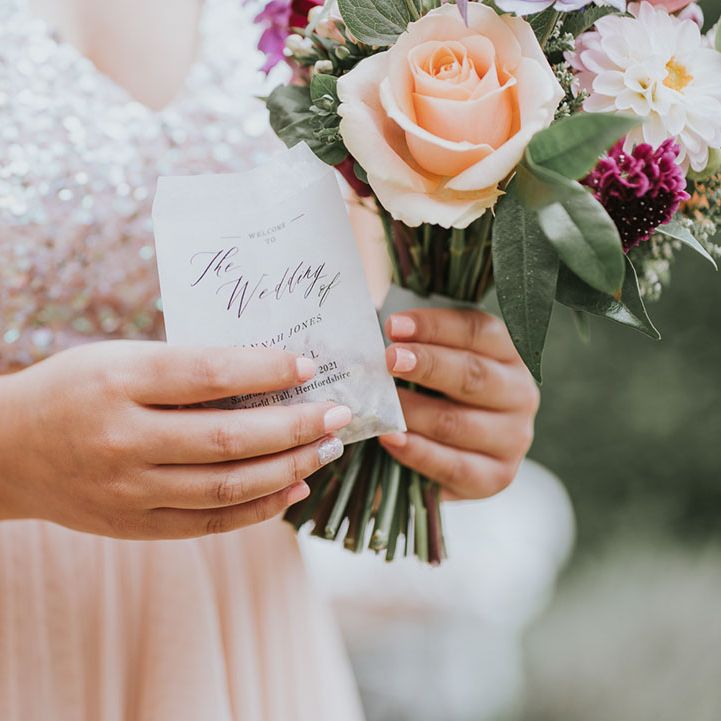 Bridesmaid in blush pink sparkly dress holding special scented confetti and assorted wedding bouquet