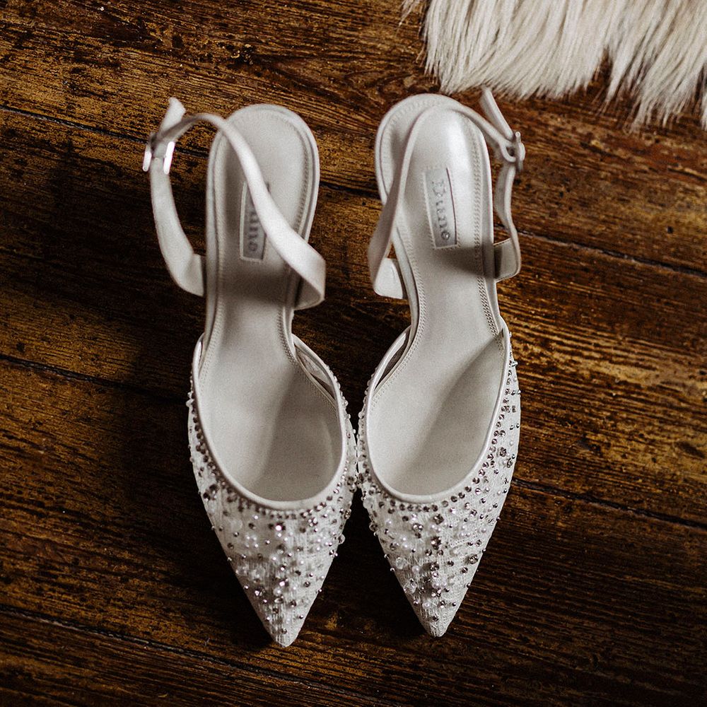 White stiletto ankle strap Dune wedding shoes with beads and diamanté embellishments