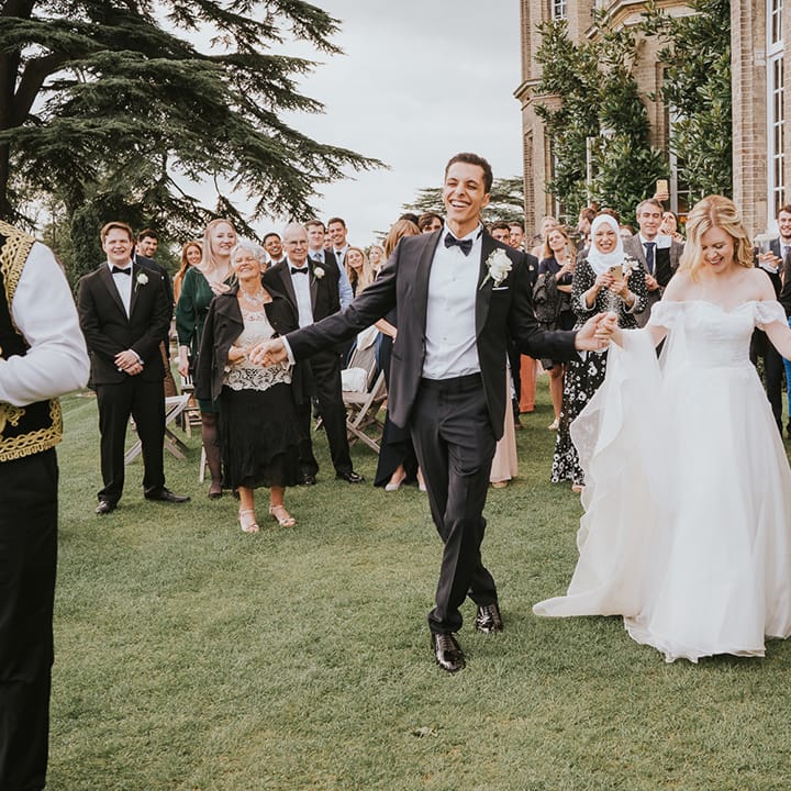 Bride and groom have fun hat their wedding with the Zaffa band 