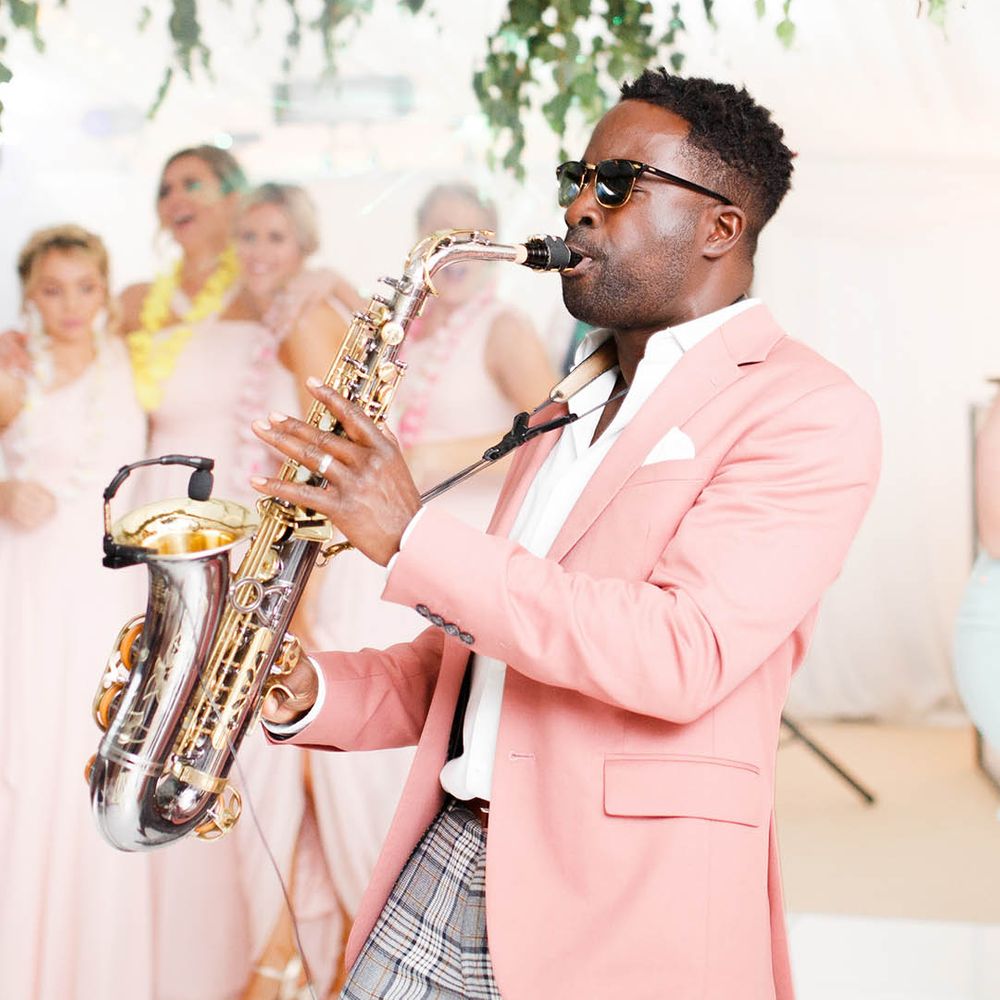 Saxophonist in a pink jacket playing at the Coddington Vineyard wedding venue 