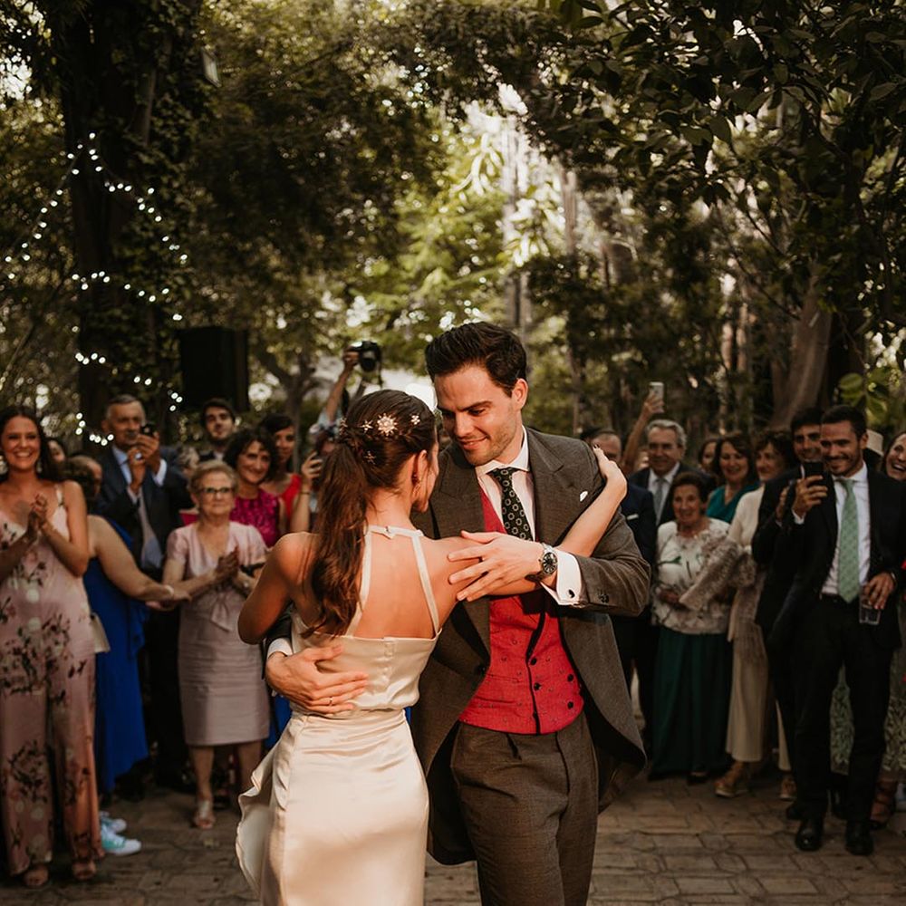 Choreographed first dance with bride in a satin midi wedding dress at outdoor Malaga destination wedding 