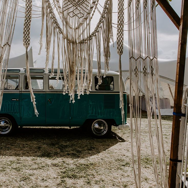 Macrame wedding decor beside vintage VW camper van