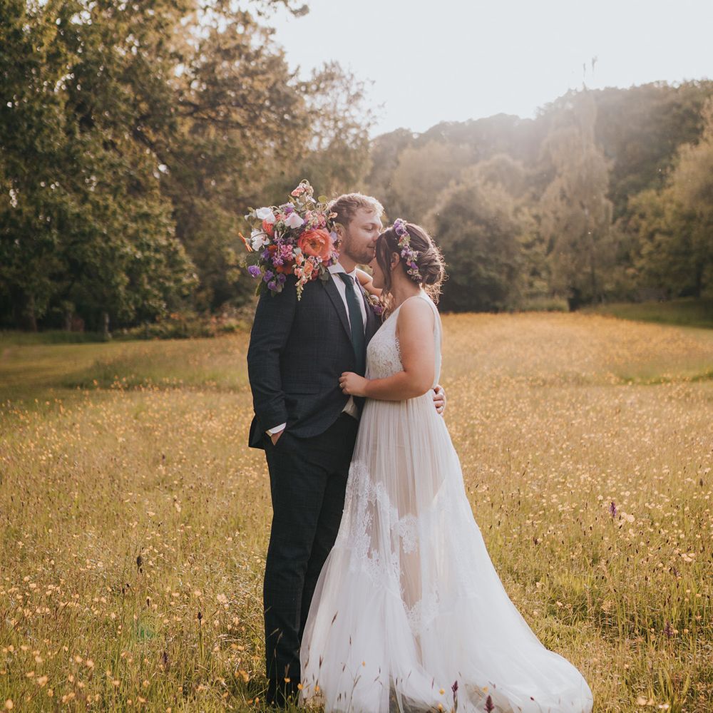 Bride & groom during outdoors golden hour couples portraits in field