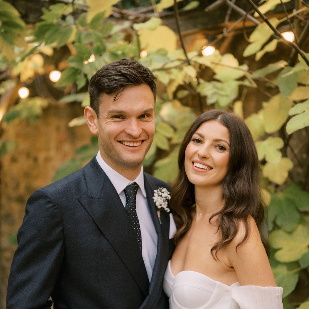 Groom in dark suit with spotted tie with bride in Bon Bride corset style wedding dress for rustic luxe wedding at The Tythe Barn