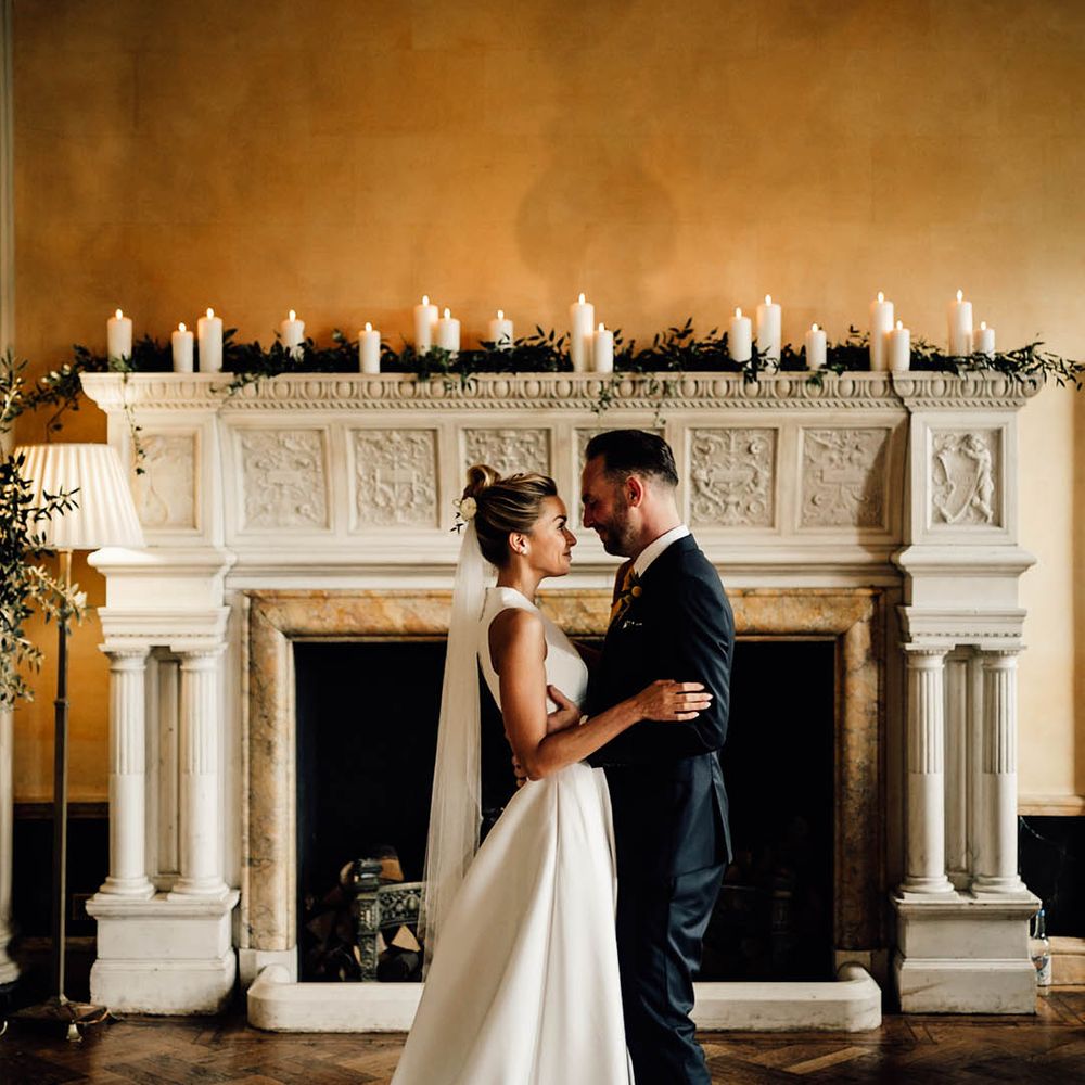 The bride and groom pose for couple portraits at Hampton Court House for their wedding day 