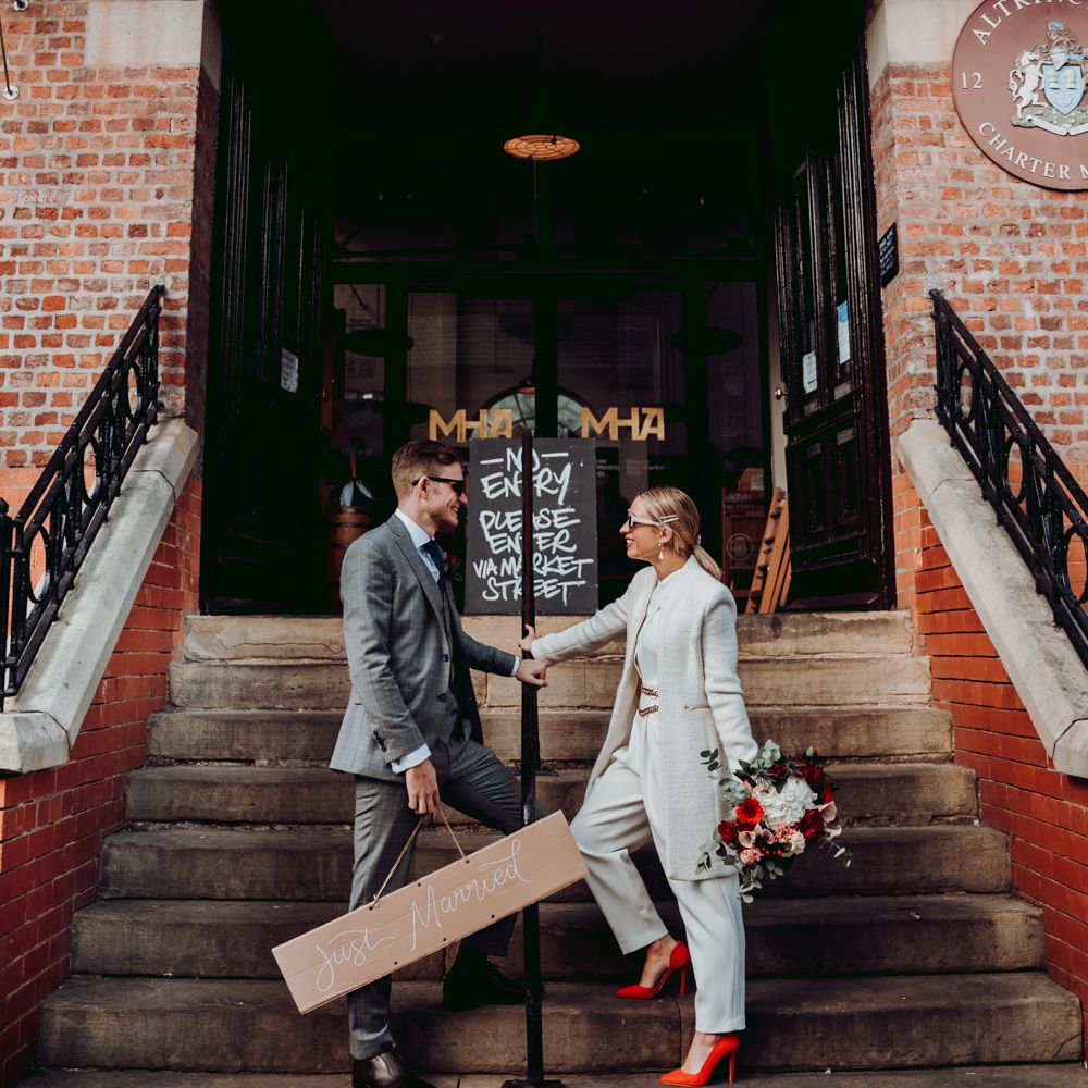 Bride and groom outside the bar after their micro wedding ceremony 