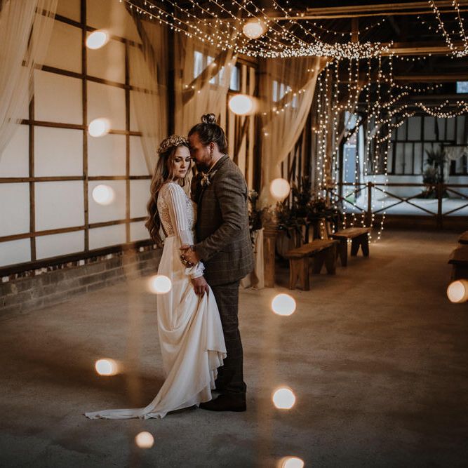 White outdoor string lighting for stunning barn wedding with boho theme
