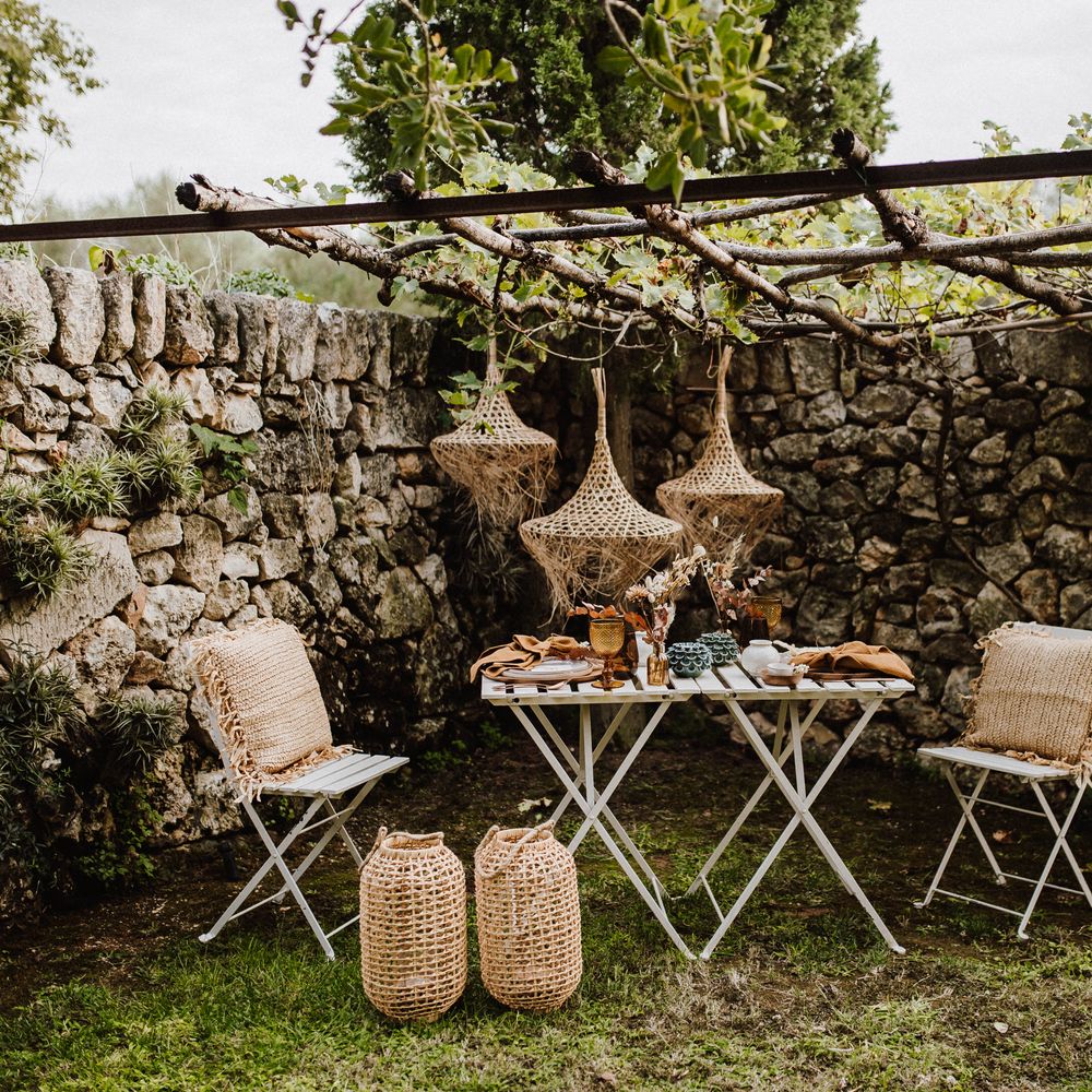 Wicker woven lampshades above white table 
