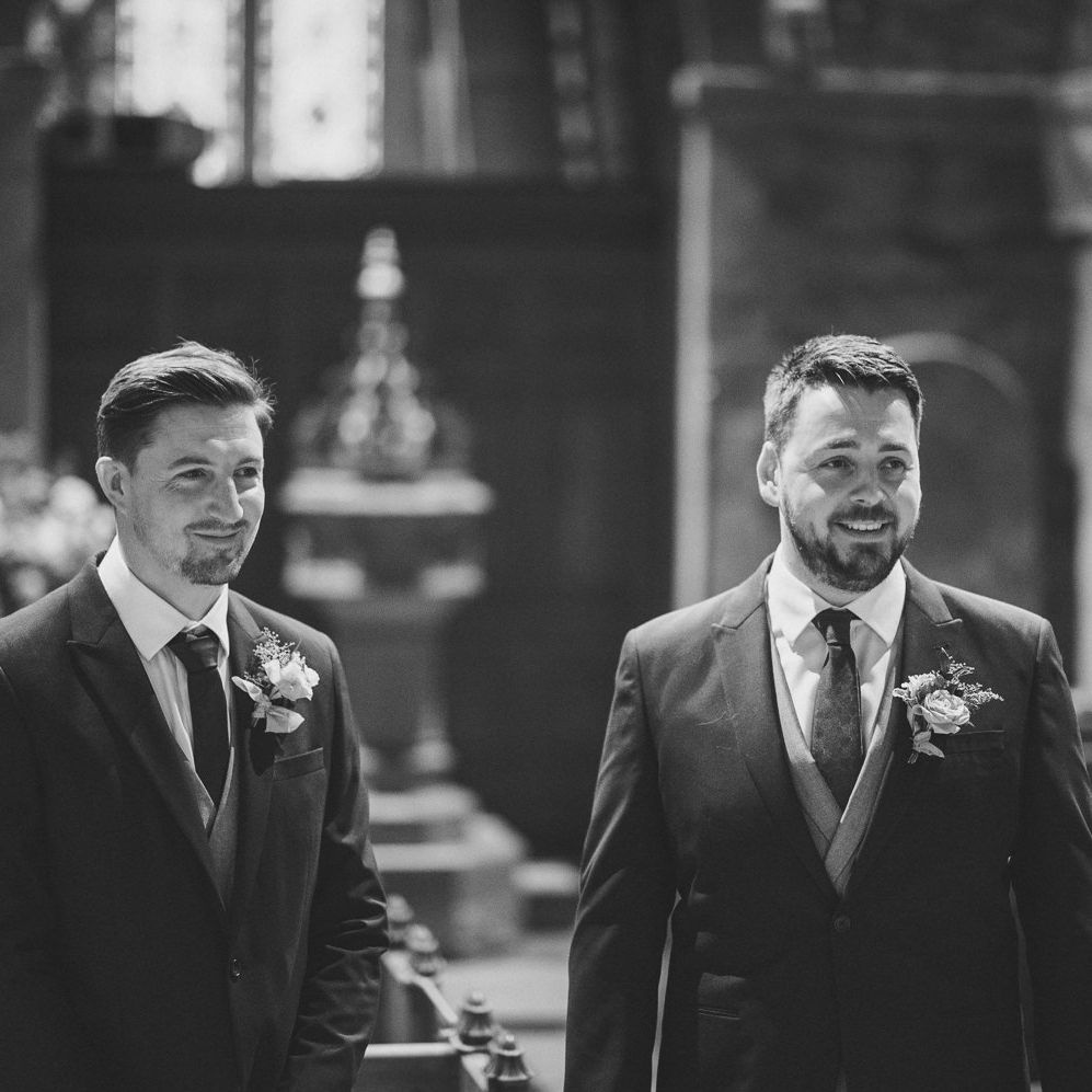 Groom smiling as his bride enters the church wedding ceremony 