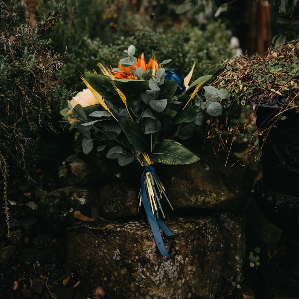 Green, orange and blue tropical wedding bouquet for farm wedding in Lancashire