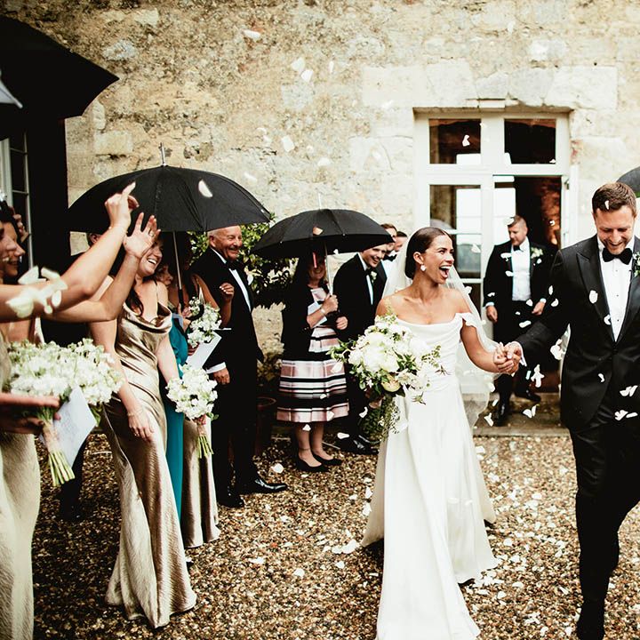 Bride & groom walk together hand in hand