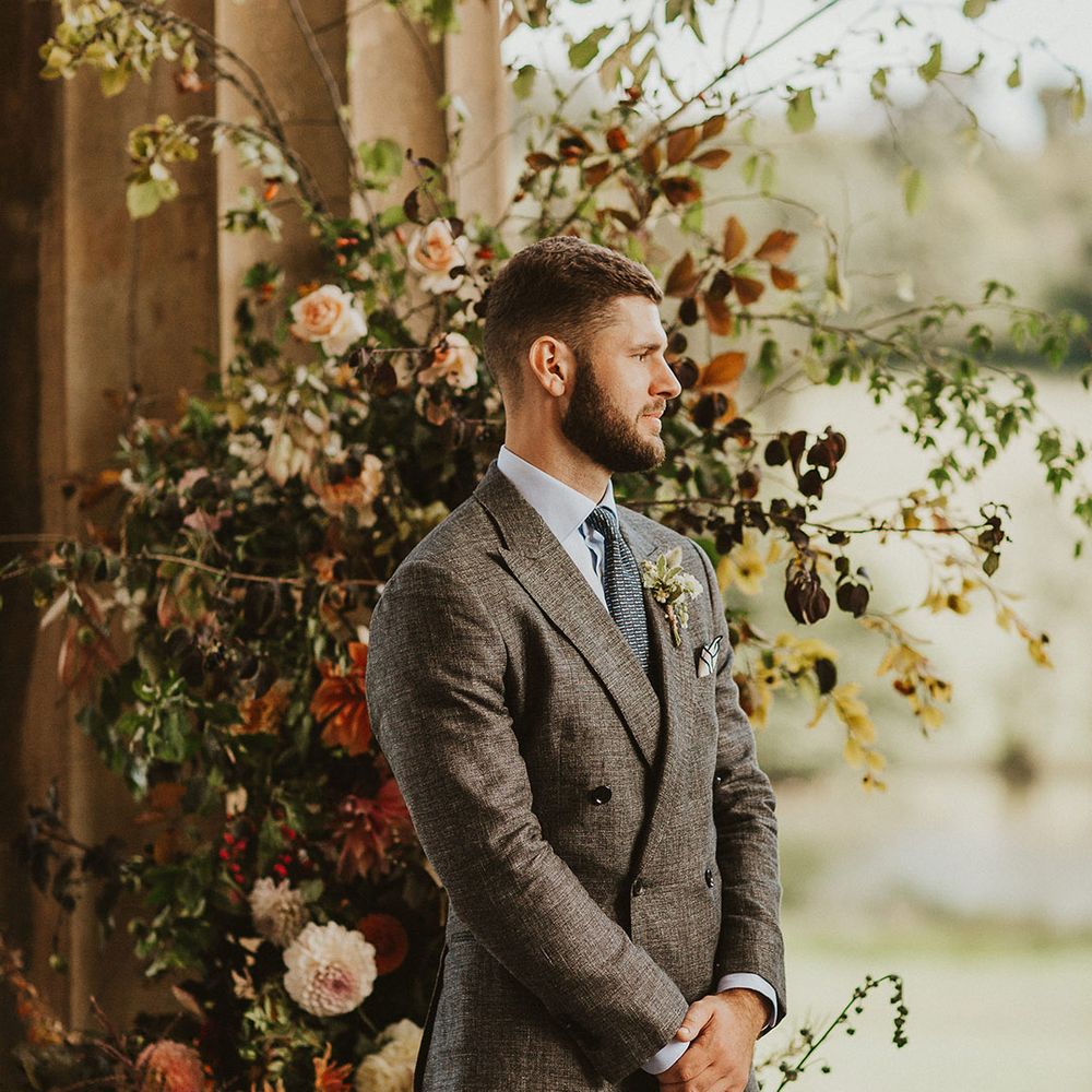 Groom awaits his brides arrival during wedding ceremony