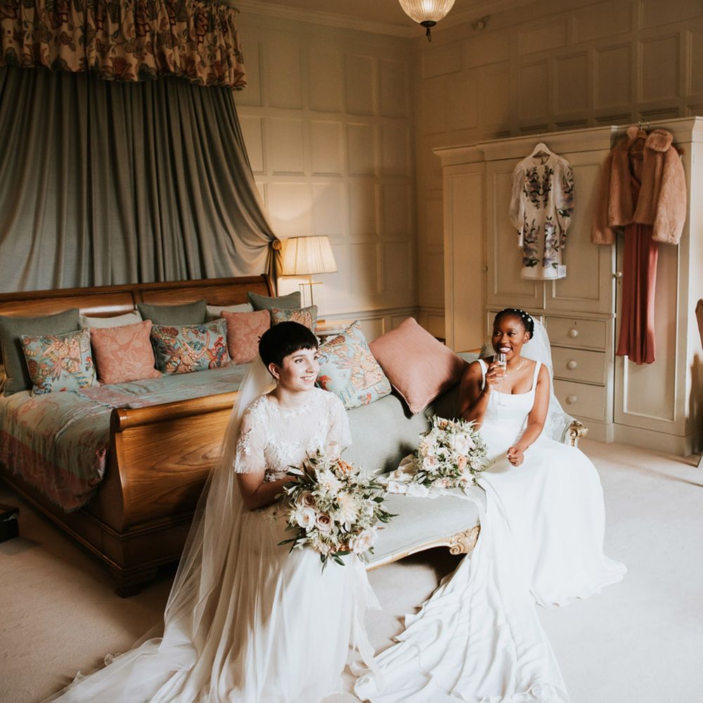 two brides sitting in the bridal suite at Elmore Court drinking Champagne 