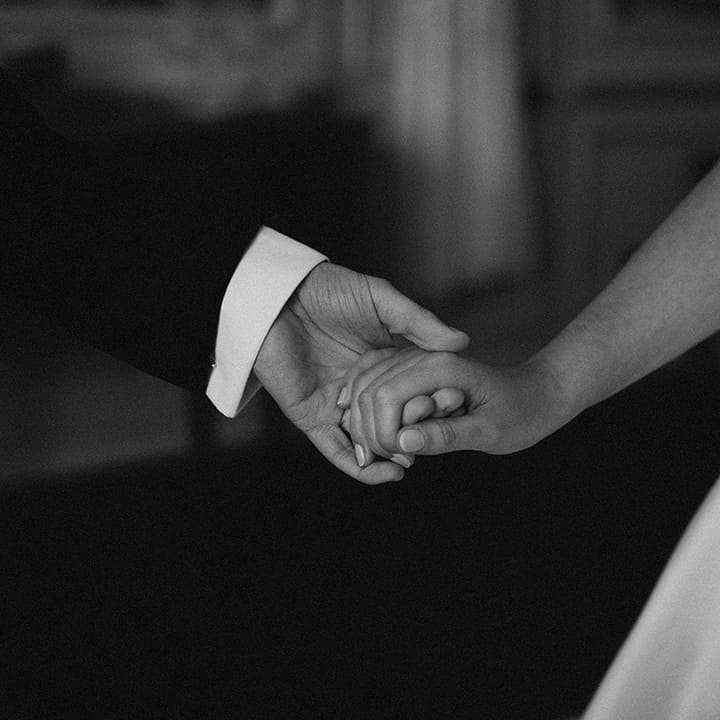 The bride and groom hold hands for their traditional country house wedding at Brympton House 