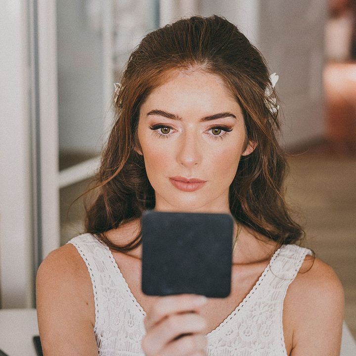 bride with long dark hair with natural bridal makeup up and winged eyeliner 
