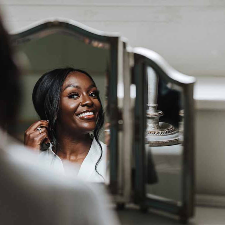 Bride doing bridal preparations at Lains Barn wedding venue Oxfordshire 