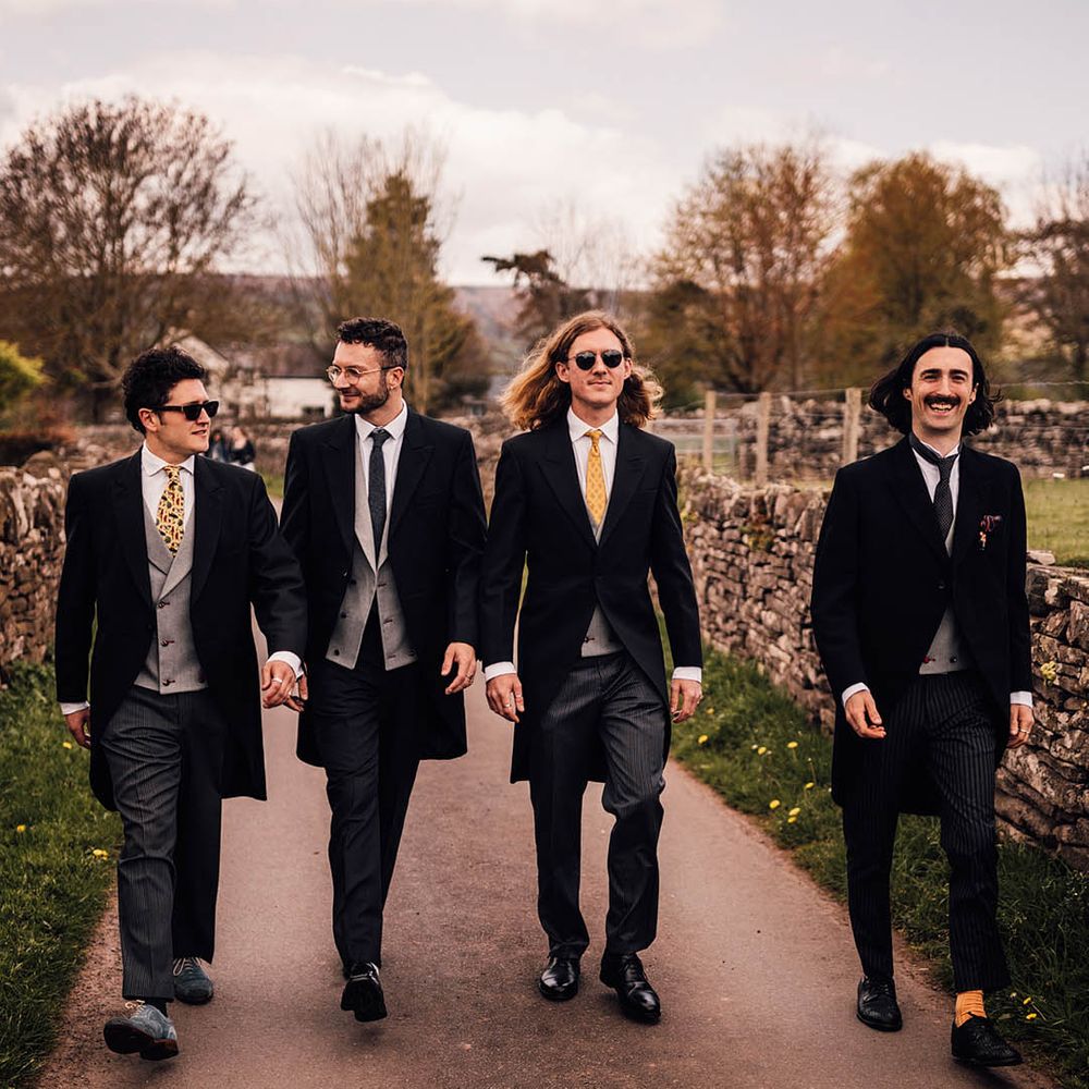 Groomsmen wedding group photo in morning suits and sunglasses 