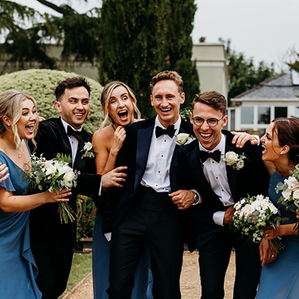 Wedding I Do Crew in dusky blue bridesmaid dresses and black tuxedos for classic country house black tie wedding 