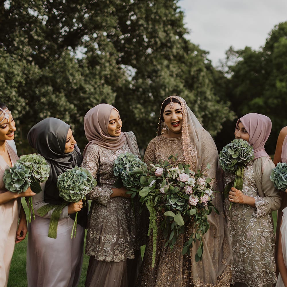 Bride in a gold dress with her bridesmaids 