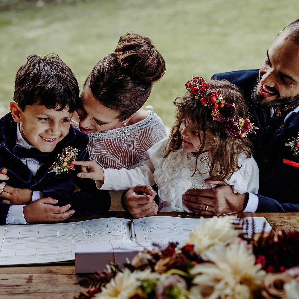 Bride & groom with their children during wedding ceremony
