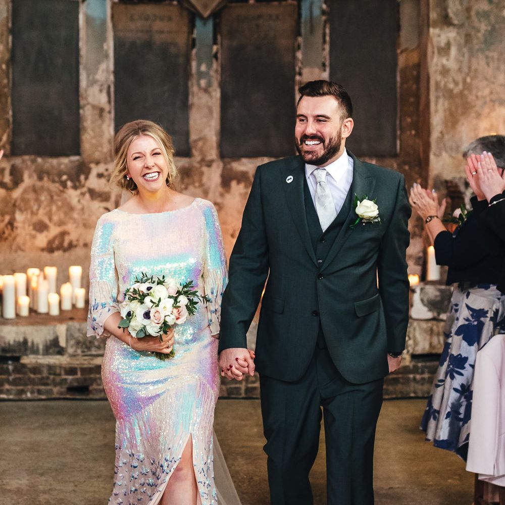 Bride & groom walk down the aisle together after wedding ceremony