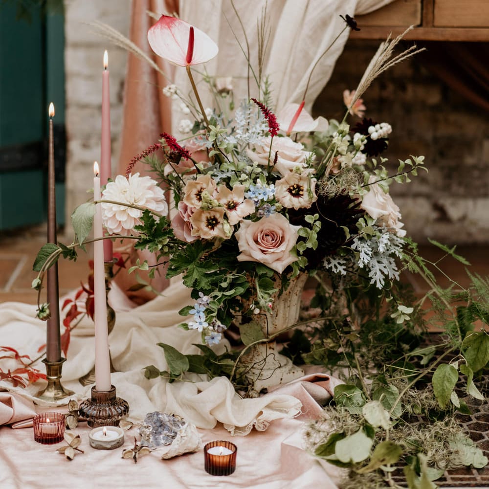 Romantic pink and green wedding flowers with anthuriums taper candles and votives