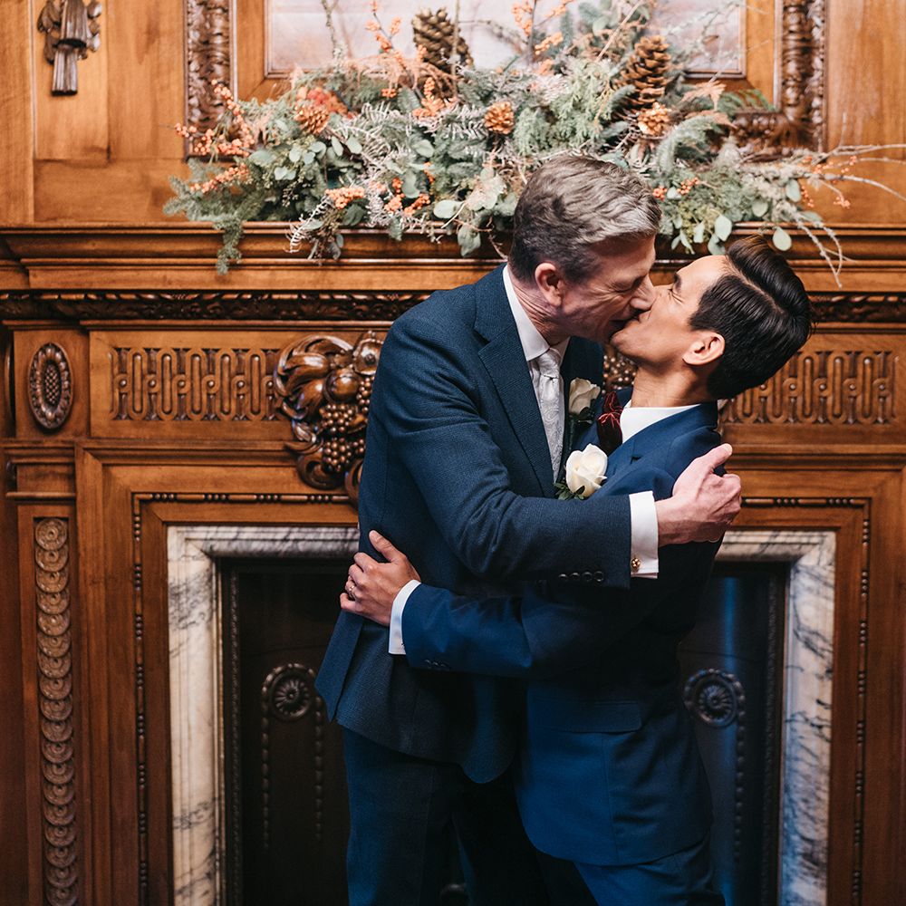Grooms kiss on the day of their wedding
