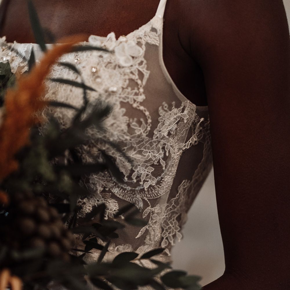 Sheer lace peplum detail on fitted wedding dress 