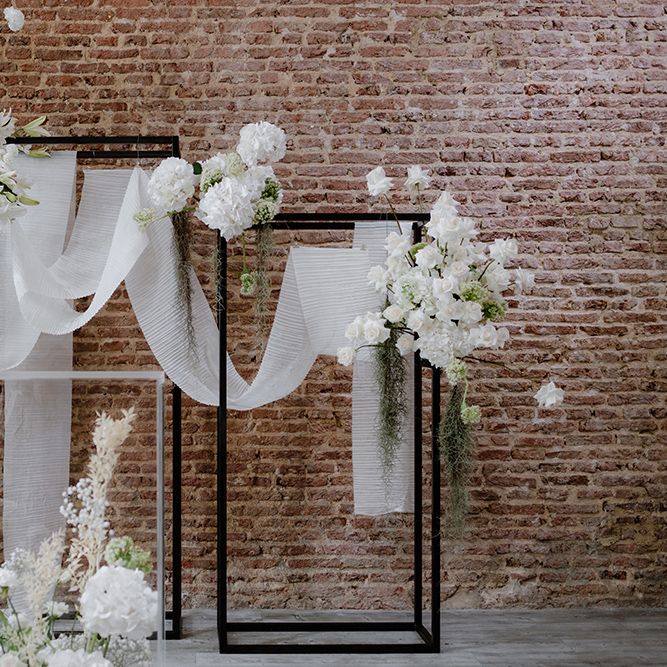 Ceremony altar wedding decor with black frames, white flowers and drapes 