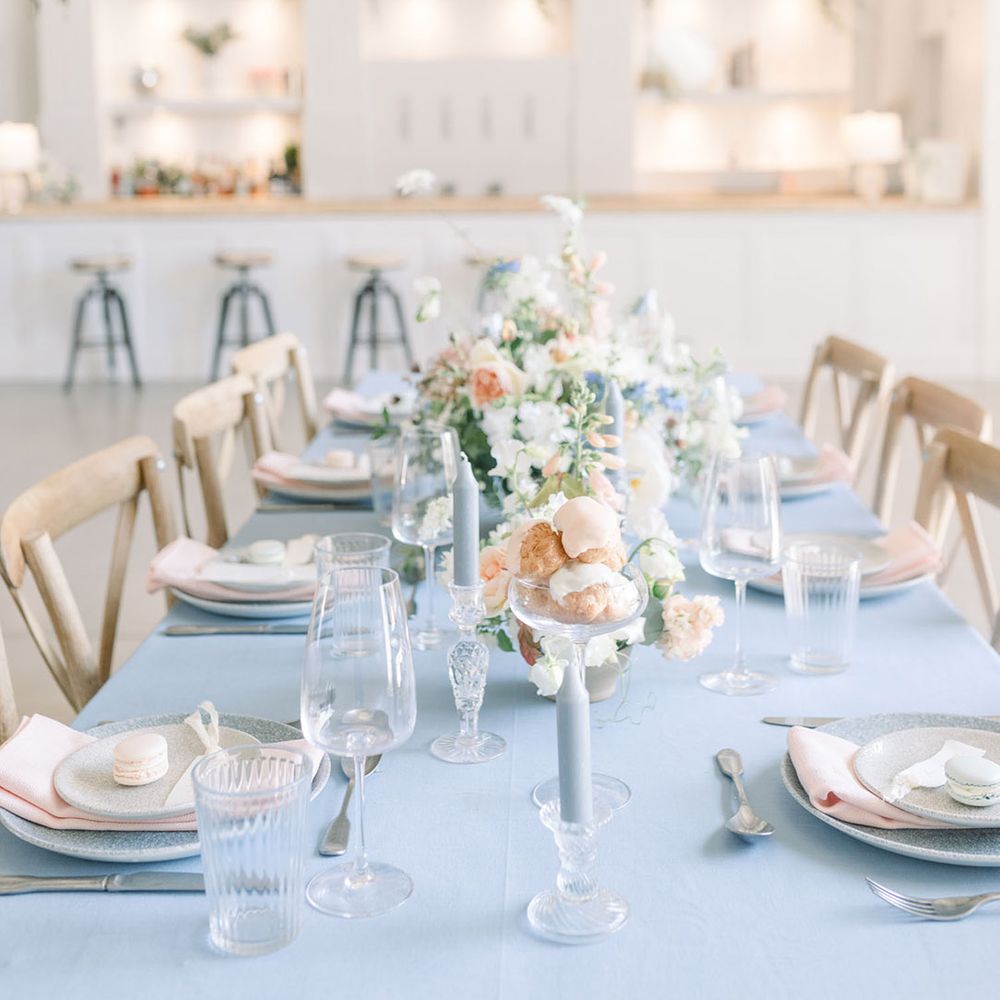 Choux buns covered in peach icing and floral centrepiece wedding table decor at intimate The White Barn wedding reception 