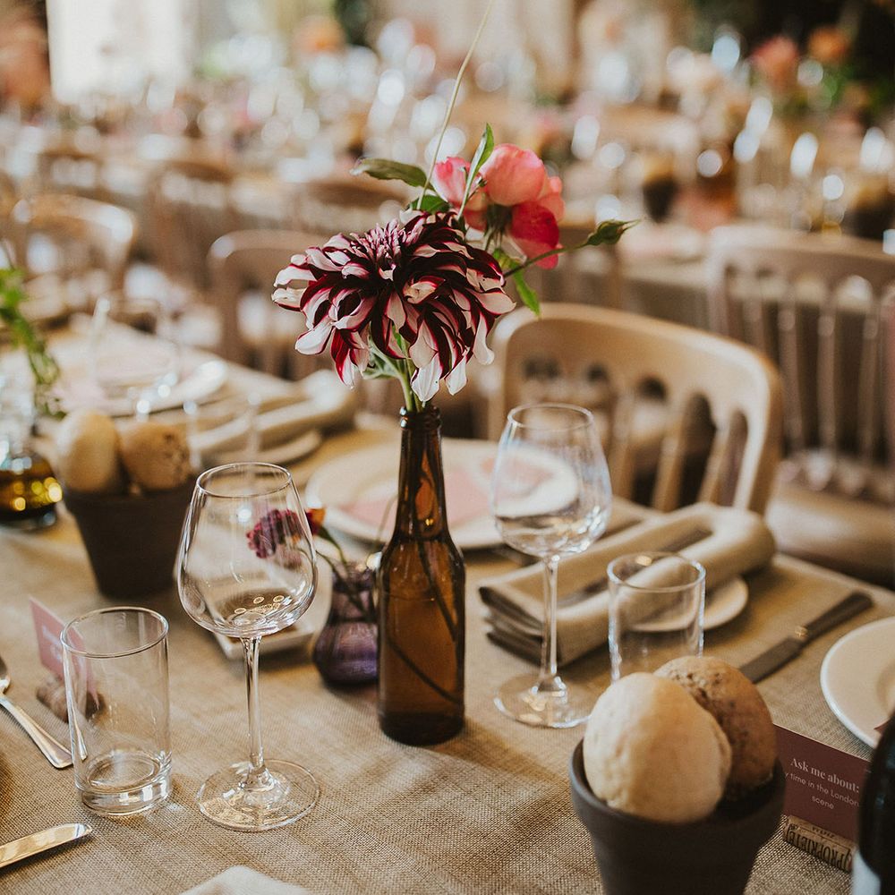 Rustic tablescape complete with florals and pink stationery