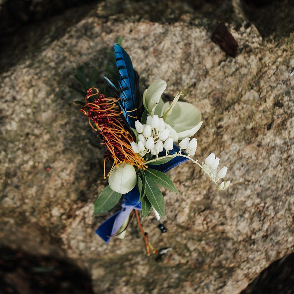 buttonhole flower with snowdrops and feathers 