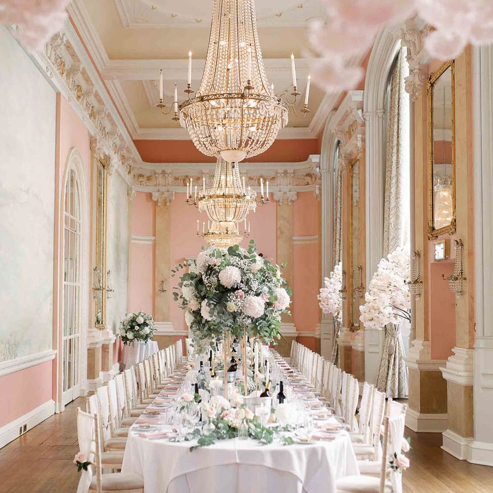 Versaille styled room complete with gold trims and blush pink colour scheme and grand hanging chandeliers 