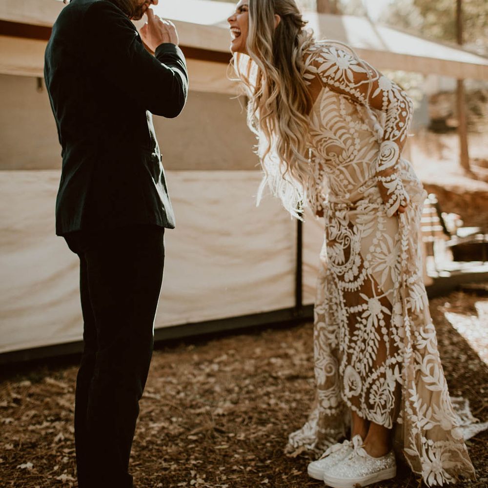 Bride & groom laugh with one another on their wedding day