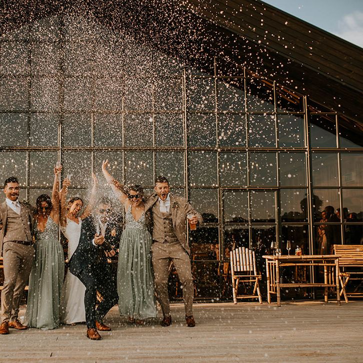 Wedding party photography popping champagne at Botley Manor