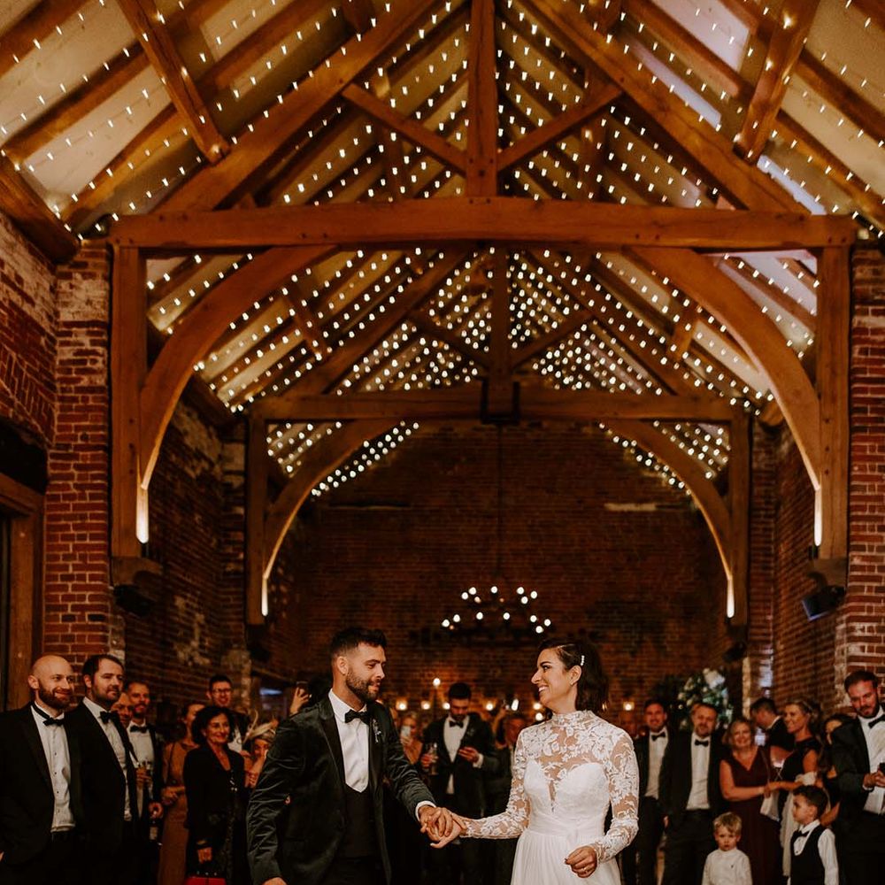 Hazel Gap Barn wedding venue with fairy light ceiling lightning the bride and grooms first dance