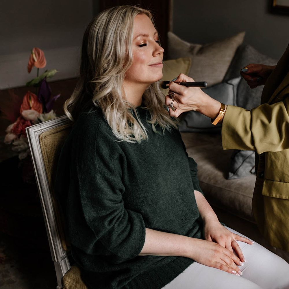 Bride on the wedding morning having her hair and makeup done
