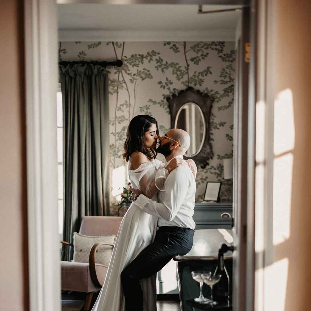 Bride and groom embracing in one of the function rooms at Elmley Nature Reserve - Kent wedding venue 