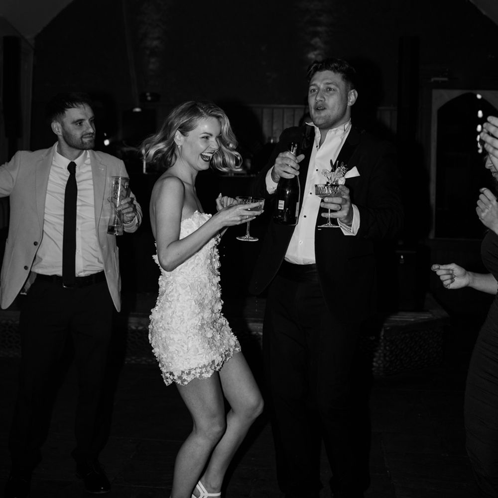 The bride and groom dance together at their wedding reception having a great time 