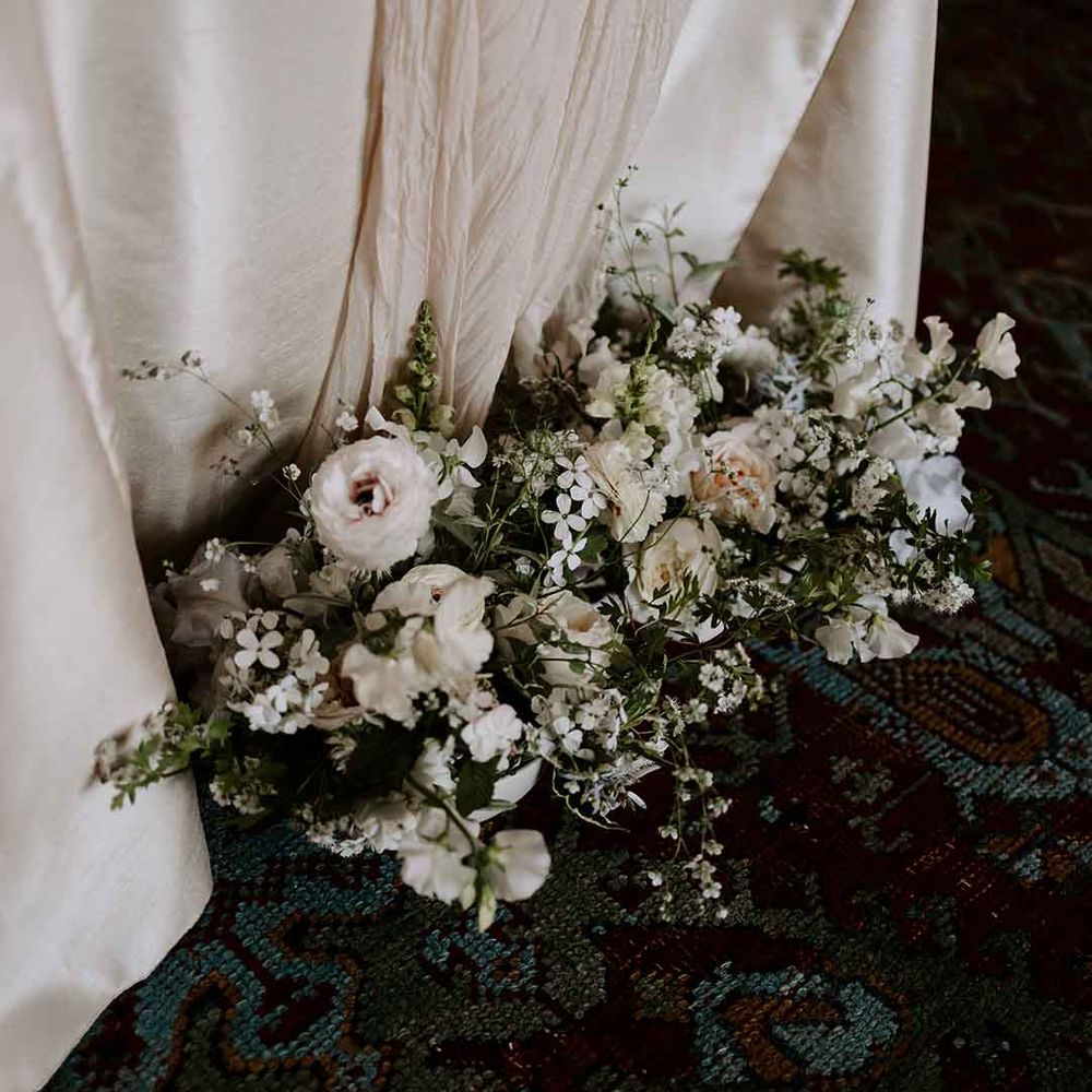 white wedding flower arrangement with foliage 
