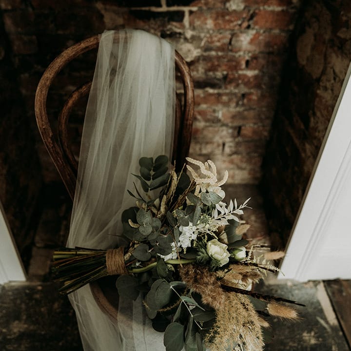 The bride's wedding veil and neutral wedding bouquet for the natural theme wedding at Aswarby Rectory 
