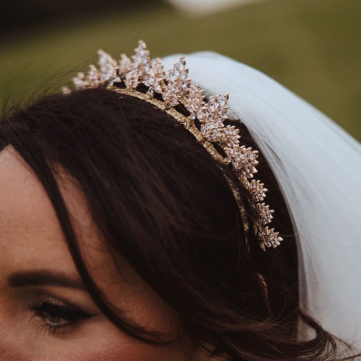 Bride wearing delicate gold sparkling crown tiara for classic country house wedding 