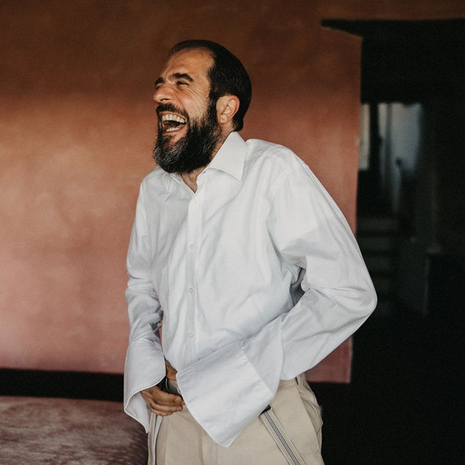 Groom laughing in Suter & Co suit