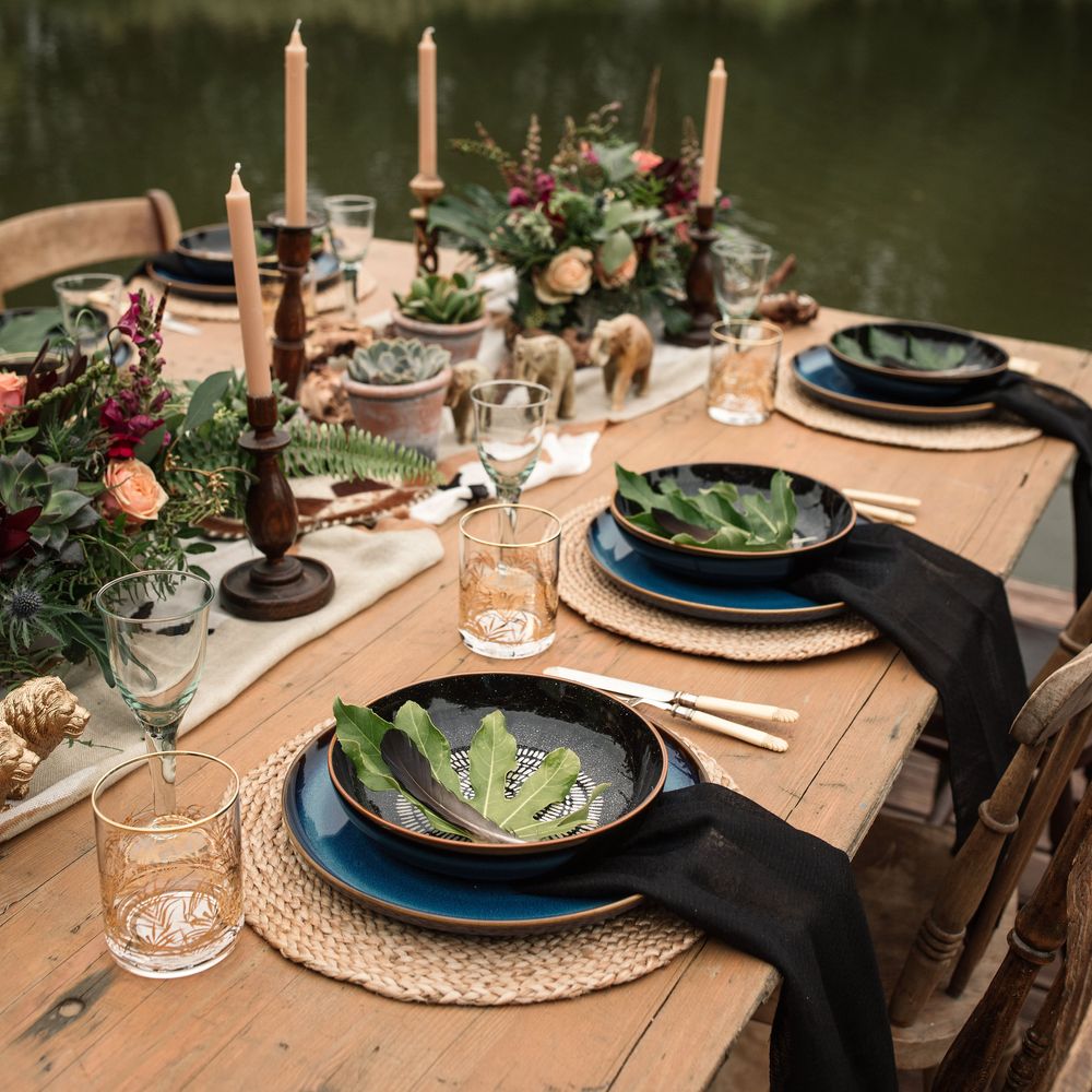 Wooden table featuring black table decor and camouflage table runner