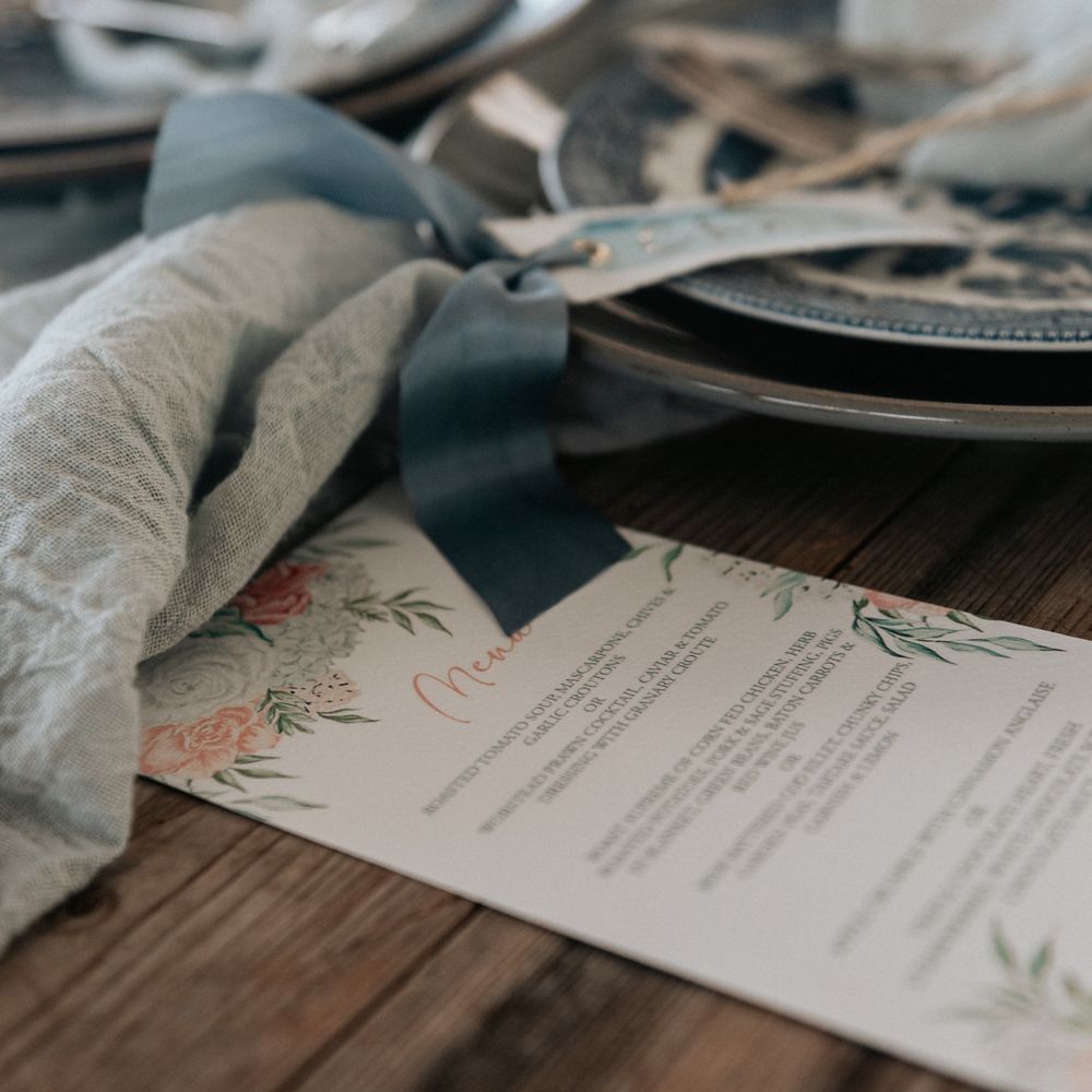 Pale grey plates with pale blue napkins tied with brown string