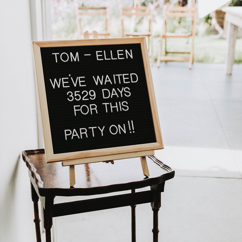 Personalised sign board set on easel on a wooden table