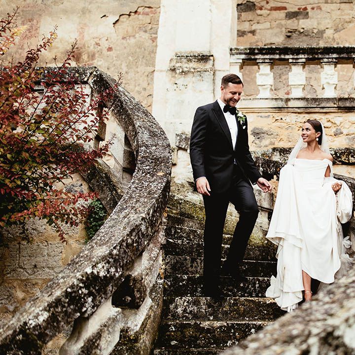 Bride & groom walk down the steps on their wedding day